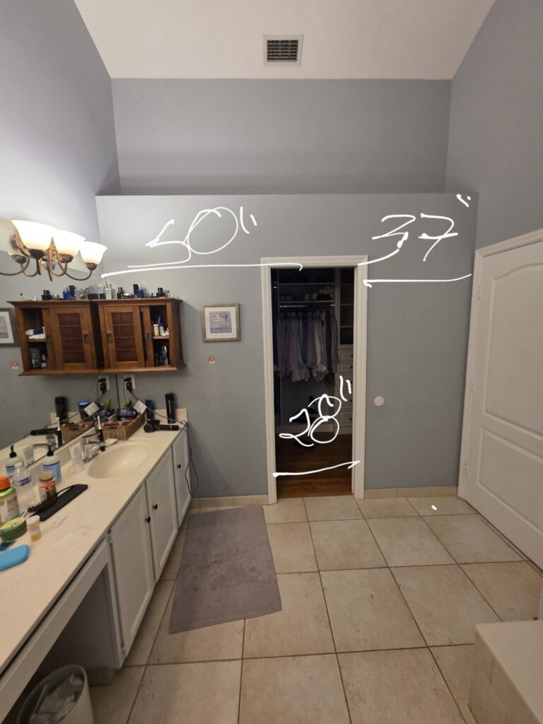Bathroom before the remodel, with the dated vanity and tile