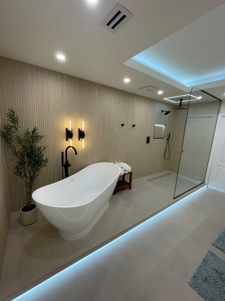 Fluted wall panels with an LED floor glow behind a freestanding tub