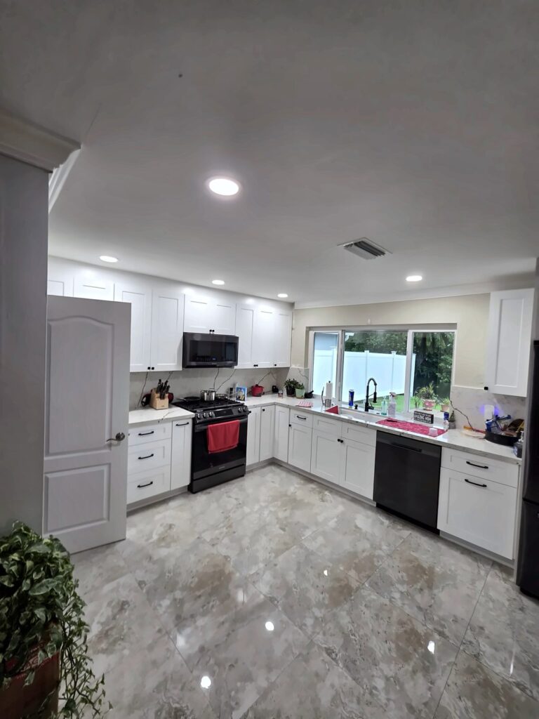 Glossy marble-look tile floor across a white kitchen