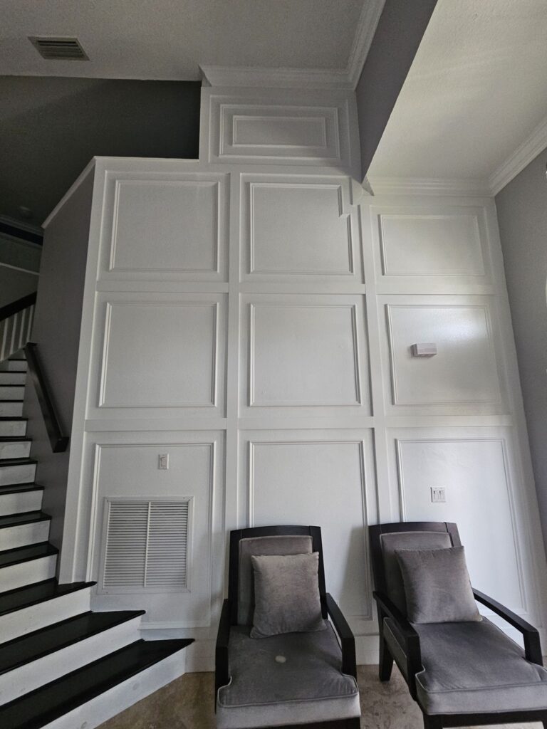Stair landing wall with grid panel molding