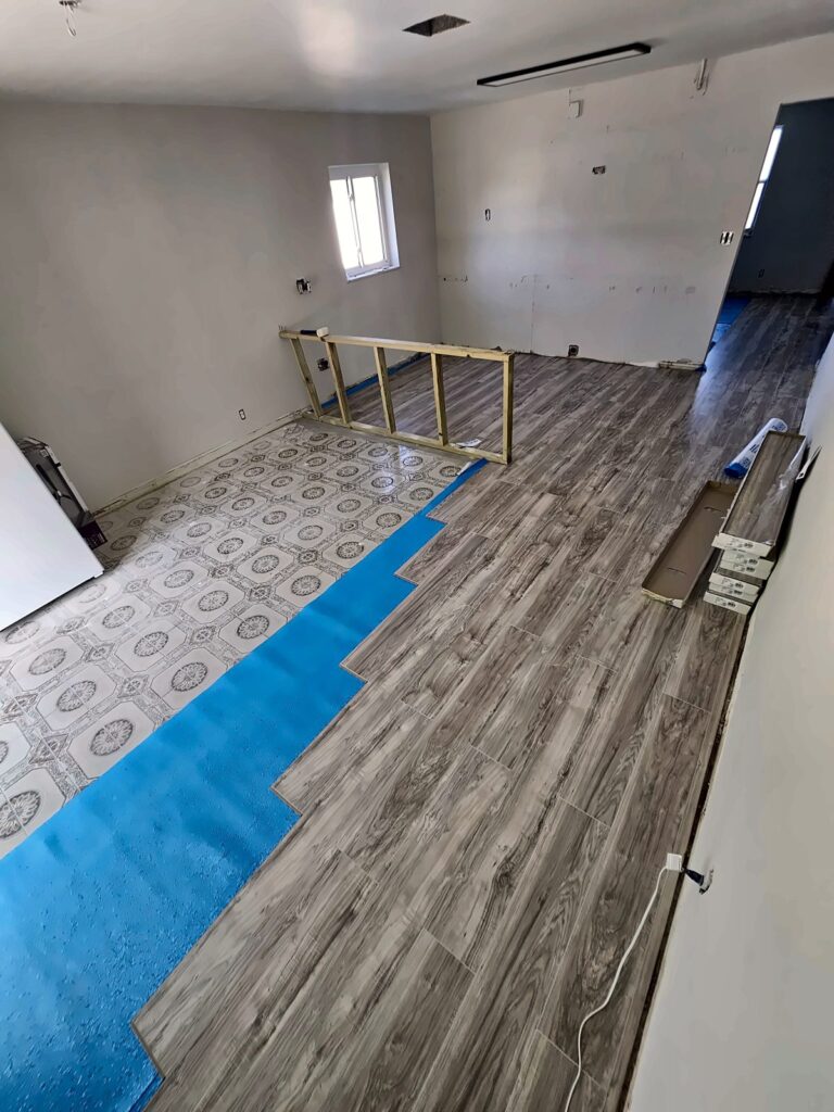 Vinyl plank flooring install in progress over underlayment